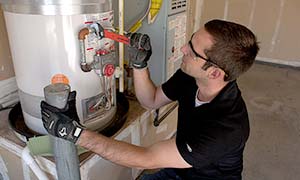 Ryan works on a water heater repair which is part of our Chula Vista plumbing services